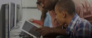 teacher sharing tablet with student with overlay cropped