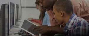 teacher sharing tablet with student with overlay cropped