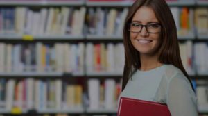 Portrait of a smiling student in a library with overlay cropped