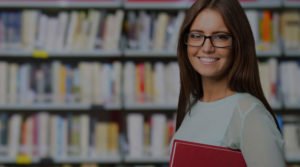 Portrait of a smiling student in a library with overlay cropped