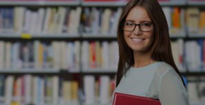 Portrait of a smiling student in a library with overlay cropped