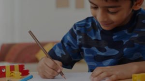 Boy enjoying drawing at home with overlay cropped