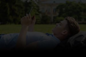 Student reading off of tablet with black overlay